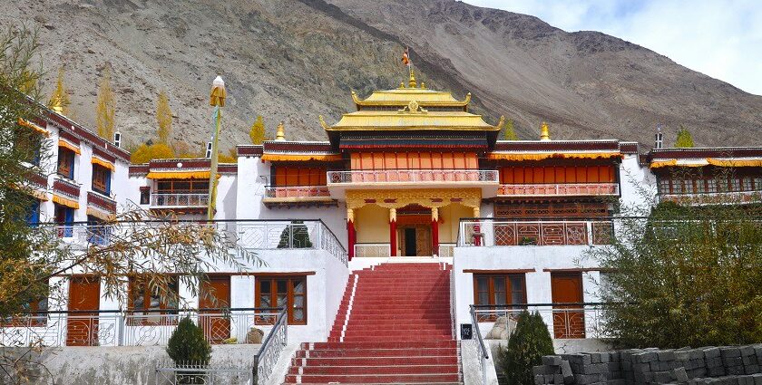 A breathtaking view of a monastery with stunning architecture surrounded by hills.