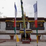 A breathtaking frontal view of a colourful monastery in Ladakh during the daytime.