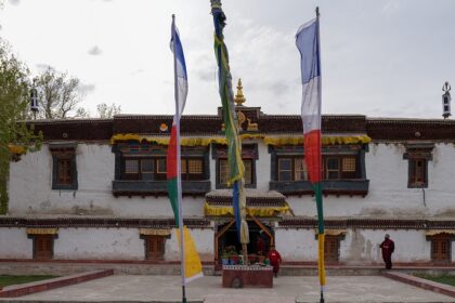 A breathtaking frontal view of a colourful monastery in Ladakh during the daytime.