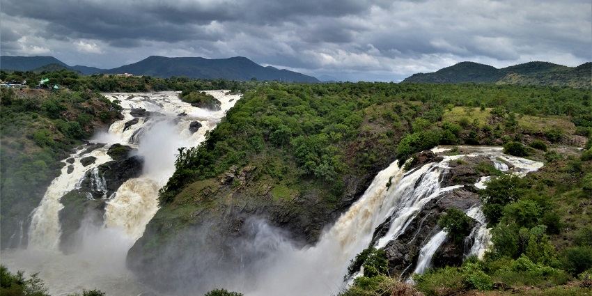 A bird’s eye view of cascading waterfalls in Shivanasamudra surrounded by lush greenery.