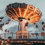 A group of friends joyfully enjoying an adventurous ride, embracing the theme park.