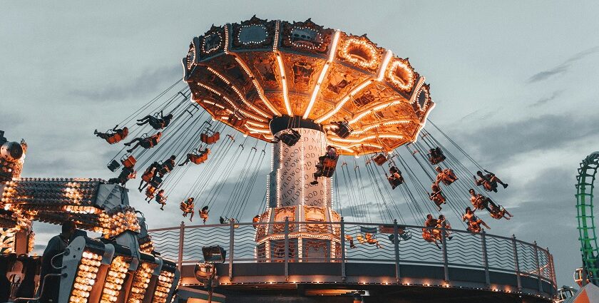 A group of friends joyfully enjoying an adventurous ride, embracing the theme park.