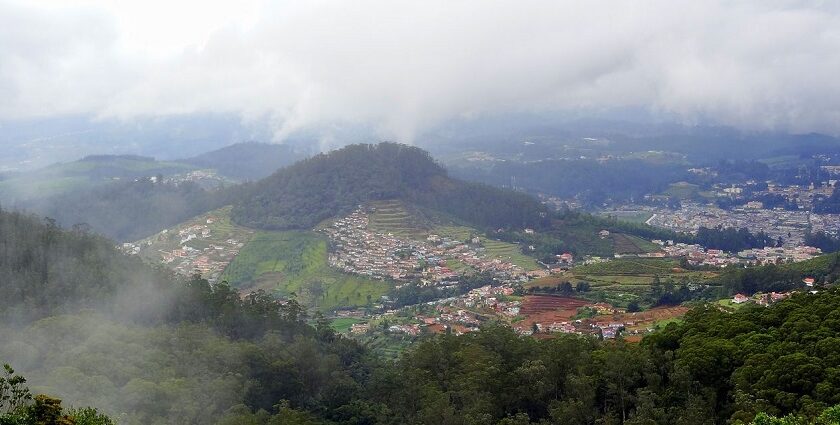 Aerial view of Ooty showcasing green hills and city landscape.