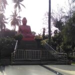 Buddha statue in Siddhartha Garden and Zoo, showcasing peaceful surroundings and nature.