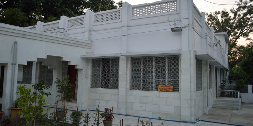 View of the temple surrounded by lush trees and shrubs