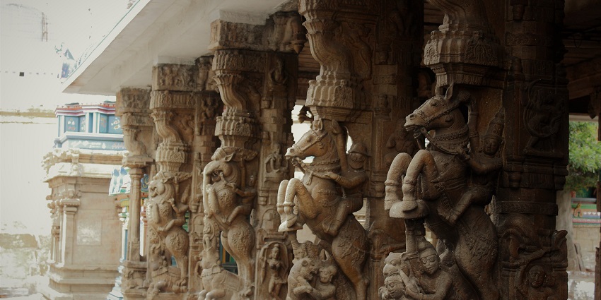 Pillars in Ardhanareeswarar Temple featuring a man on a horse and other sculptures.