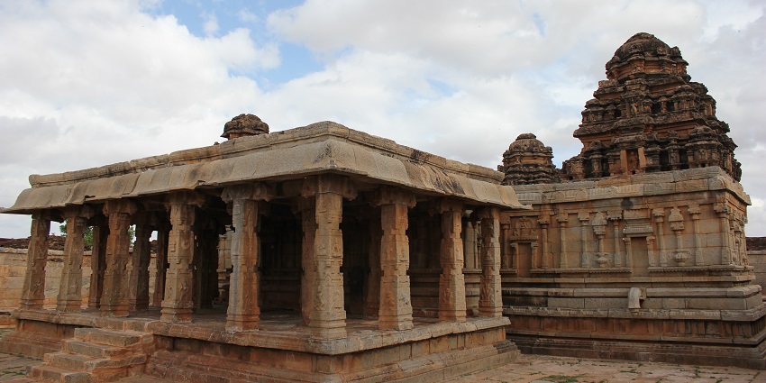A picture of a traditional Hindu temple with intricate carvings on its outer walls