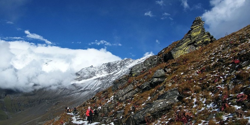 An adventurer trekking through the valleys inside Nanda Devi Wildlife Sanctuary.