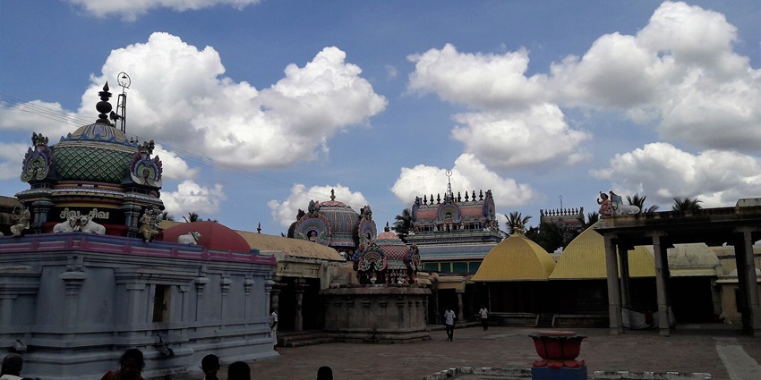 Image showing an inside view of a temple with people exploring the structure and clouds in the sky
