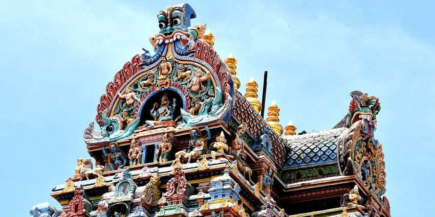 An image showing the serene Alagar Kovil Temple, surrounded by lush greenery and hills.