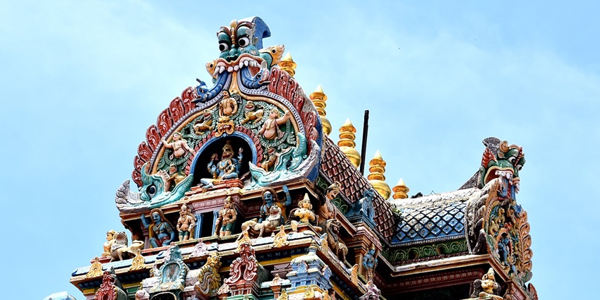 An image of the sacred Vishnu temple at Alagar Kovil, near Madurai, under a clear blue sky.