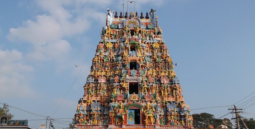 The entrance tower of Alangudi Temple with colourful sculptures and a designed chariot.