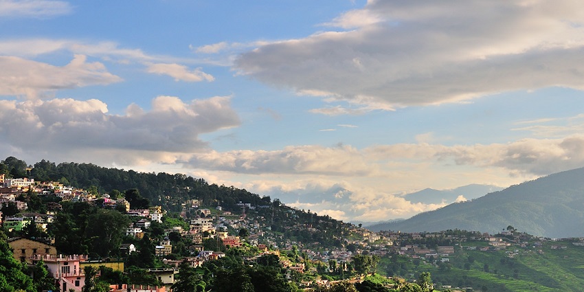 A picture of Almora with its lush forests and a stunning Himalayan backdrop.