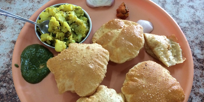 The famous street food in Haridwar is the spiced potato served with deep-fried, fluffy bread.