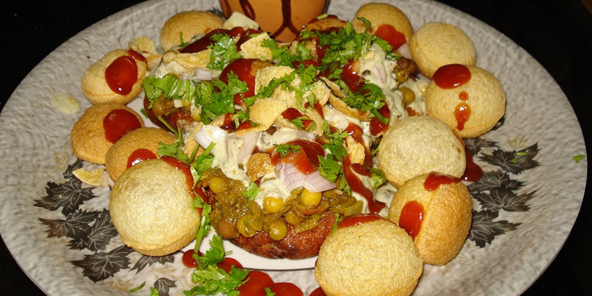The street food in Rishikesh offers spicy potato patties topped with yoghurt and tangy chutneys.