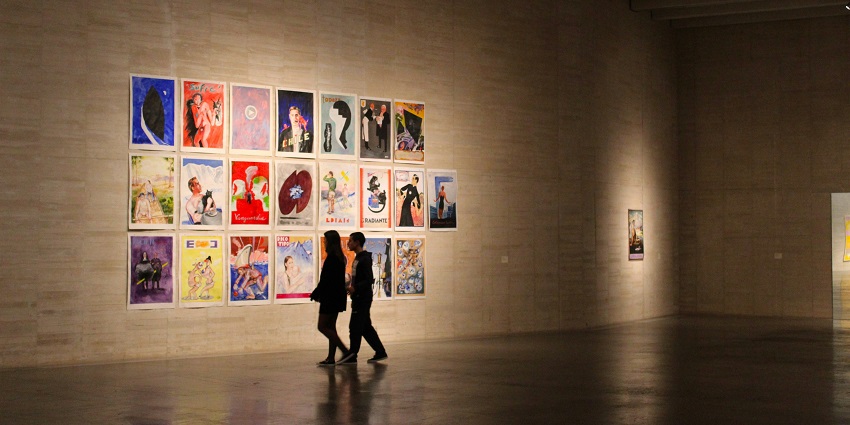 An Indian art gallery image with colourful paintings and sculptures on display