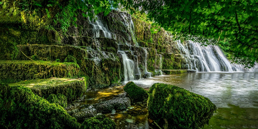 A scenic view of a stunning waterfall surrounded by greenery near Chennai, perfect for nature lovers.