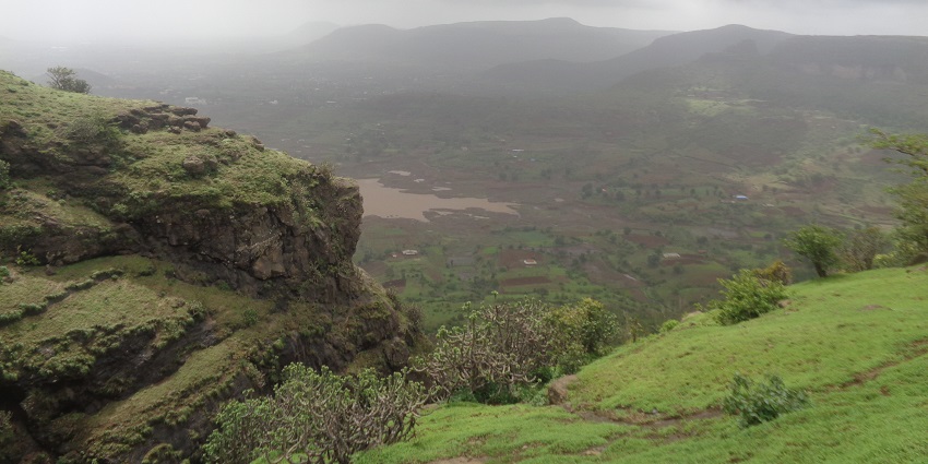 Anjaneri Hill in Nashik, with a misty landscape and lush greenery, ideal for trekking