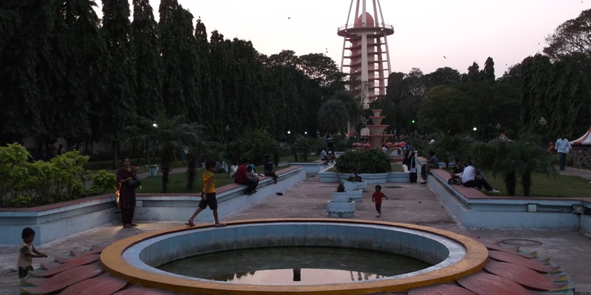 Anna Nagar Tower Park with children on wide pathways and the tower surrounded by greenery