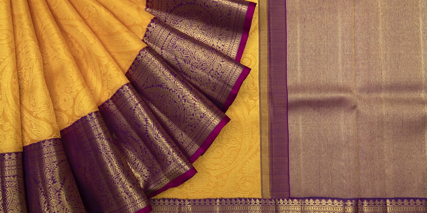 An image of the colourful silk sarees is neatly arranged inside the Aparanji Silks store.