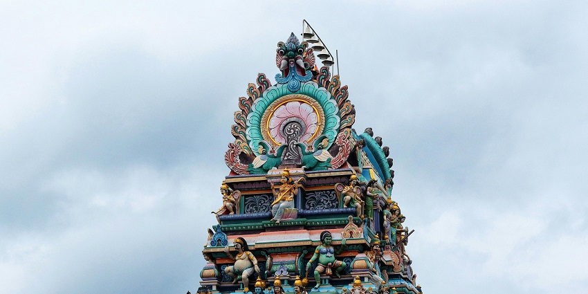 Colourful gopuram of a Puducherry temple with intricate carvings and detailed architecture.