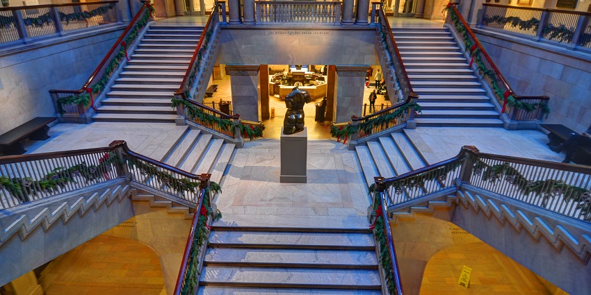Inside the Art Institute of Chicago with empty hallways, stairs and exhibits on display