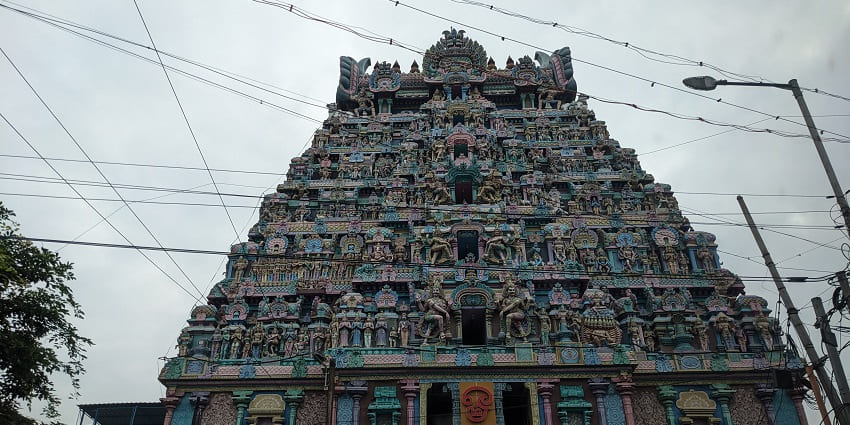 Front view of Jambukeswarar Temple showcasing intricate stone sculptures and idols.