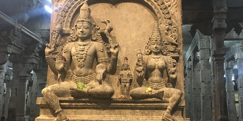 A picture of a historical temple in Trichy with idols of Lord Shiva and Goddess Parvati carved out of a rock