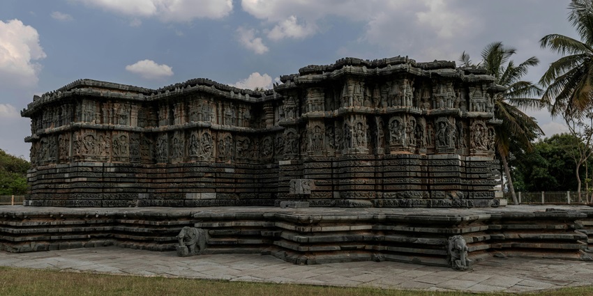 An ancient temple with intricate carvings in Tamil Nadu, showcasing detailed sculptures.