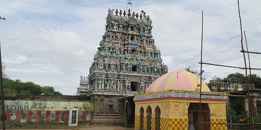Front view of Kayarohana Swami Temple with decorated gopuram and a yellow structure in front