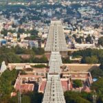 View of Arunachalam Temple from a nearby hill surrounded by trees and natural landscape