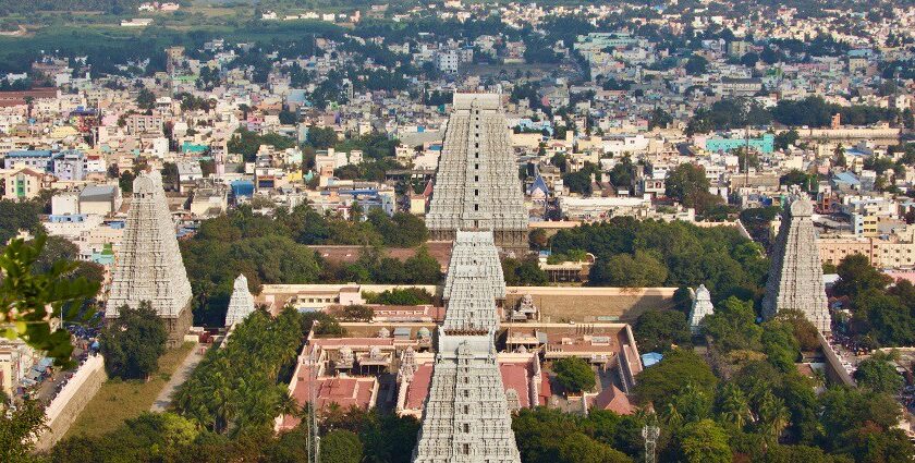 View of Arunachalam Temple from a nearby hill surrounded by trees and natural landscape