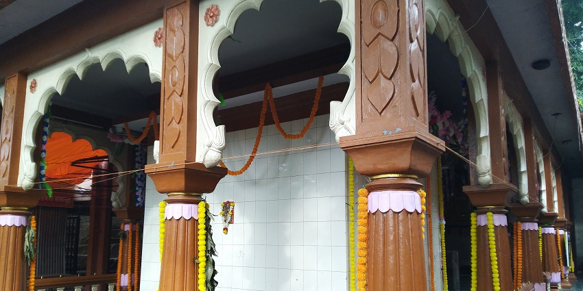 An image of Ashtabhuja Devi temple which is coloured in white along with a stupa that is gold.
