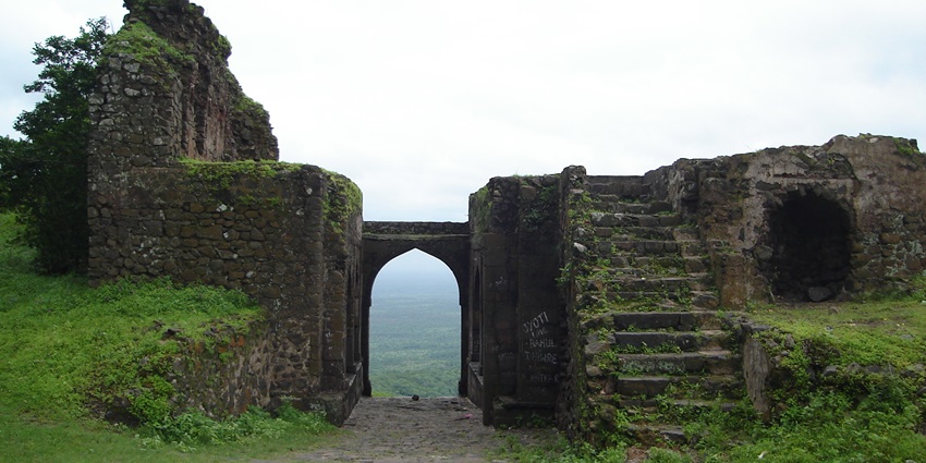 A glimpse of the iconic Asigarh Fort in Haryana, surrounded by lush green vegetation.