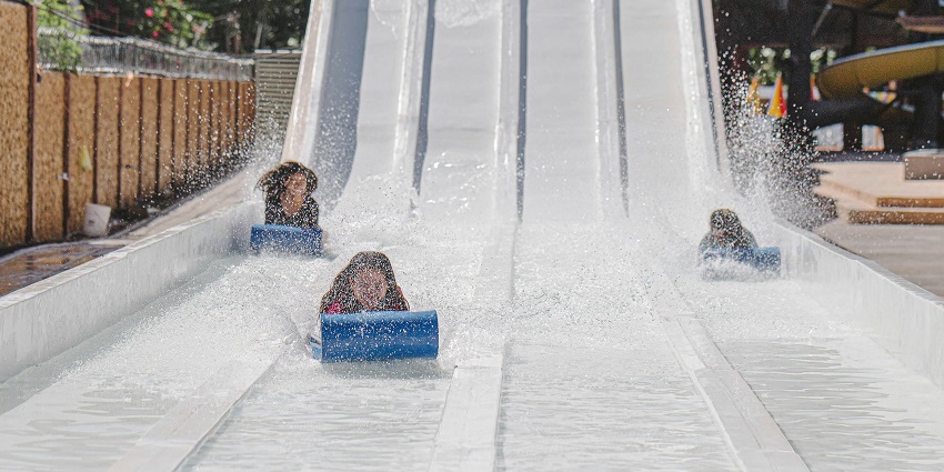 An image of people enjoying water rides at Athisayam Water Amusement Park.