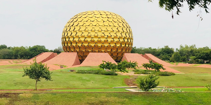 A glimpse of an architectural marvel elegantly nestled in the lush grounds of Auroville.