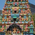 Front view of Avinashi Lingeshwarar Temple showing temple complex and a few people outside