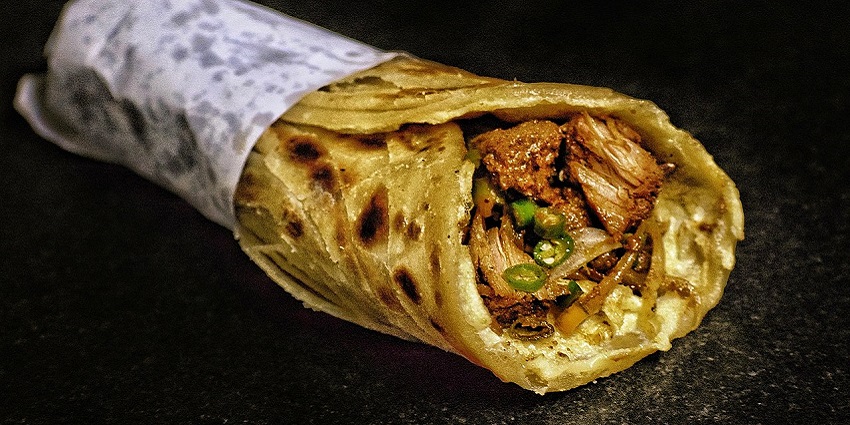 Meat pieces cooked in spices and chillies, rolled in egg and flaky roti, wrapped in paper