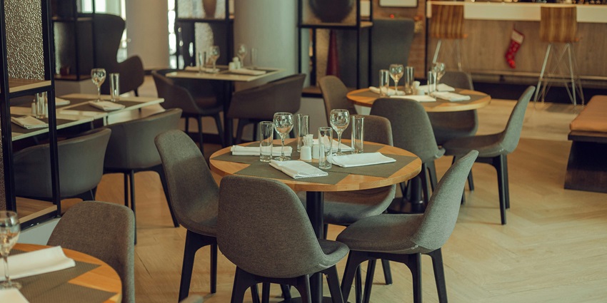 Cozy modern restaurant interior with empty tables, soft lighting—nightlife in nainital