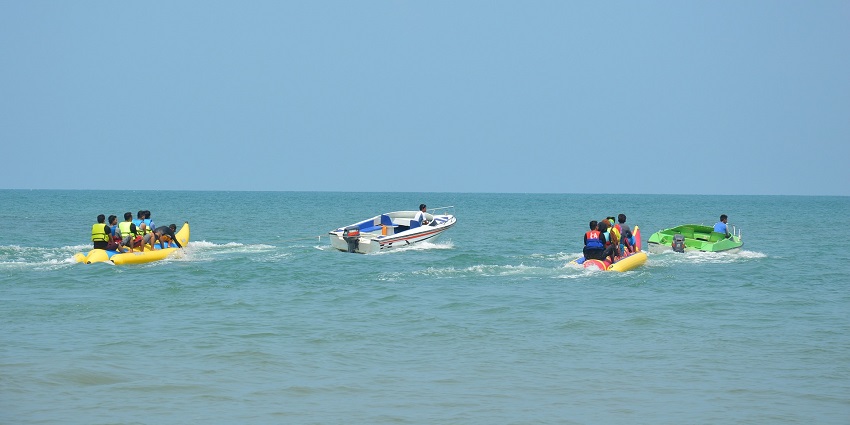 A picture of tourists enjoying the Banana Boat Ride at Dandi Beach water sports.