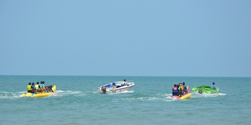 A picture of tourists enjoying the Banana Boat Ride at Nagaon Beach water sports.