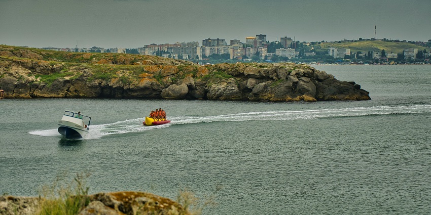 A picture of friends enjoying a banana ride, one of the best water sports near Karde Beach