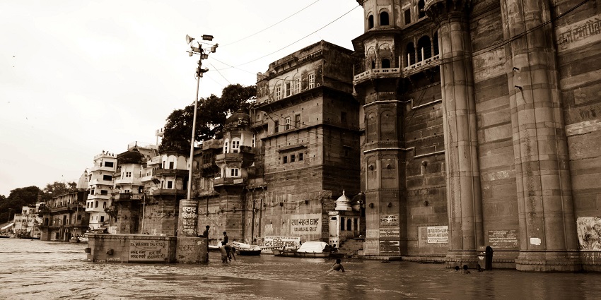 A panoramic view of the Varanasi ghats featuring steps leading down to the water