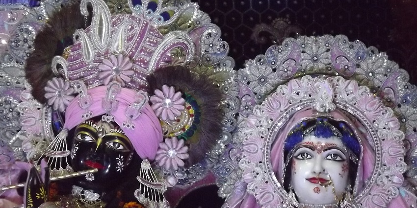 Banke Bihari deity adorned with colorful garlands and intricate decorations in a sacred temple