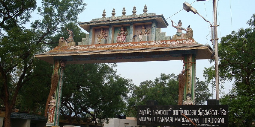 Ornate entrance gateway of the Bannari Mariamman Temple surrounded by greenery.