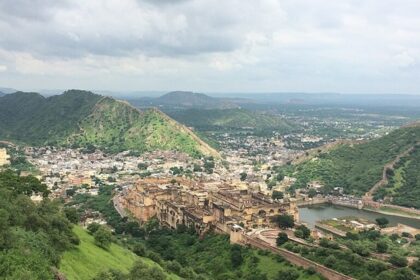 A serene view of Barua Sagar Fort, surrounded by lush greenery.