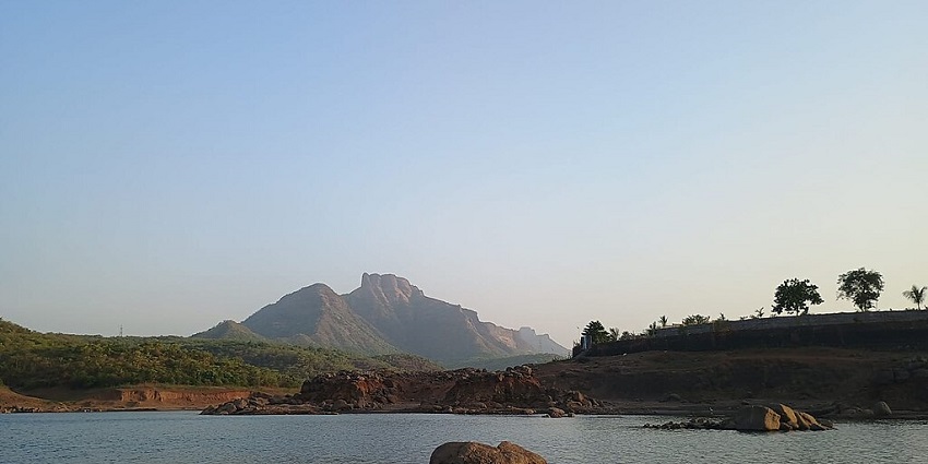 Barvi Dam near Badlapur with expansive reservoir, lush monsoon greenery, and spillway channel, situated near Kondeshwar temple.