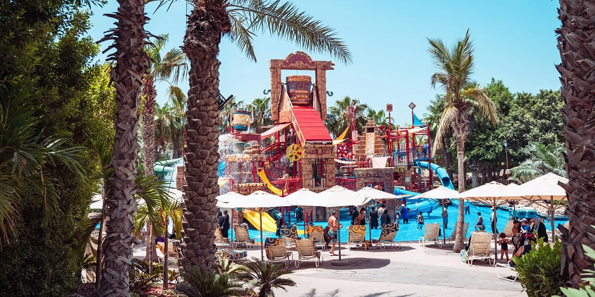 Colourful slides at a water park in action with people enjoying the attractions.