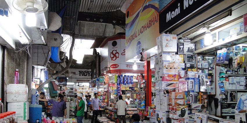 Heritage façade of Crawford Market in Mumbai with clock tower and arched entrance.
