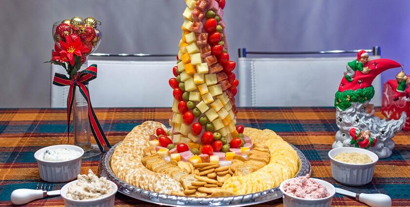 A picture of a salad dressing with numerous fruits and vegetables served in a decorative manner